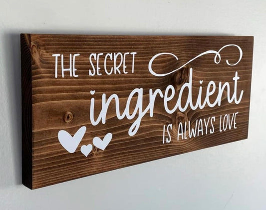 Wooden Sign: The secret ingredient is always love